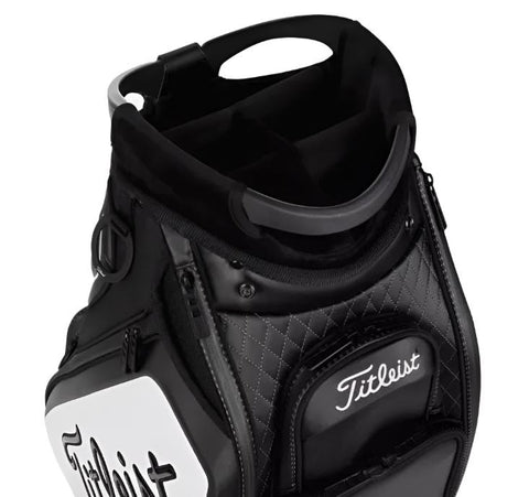 A close-up of the Titleist Tour Golf Bag in Black/White by Titleist, featuring quilted detailing, multiple compartments, and top dividers for organized golf club storage.