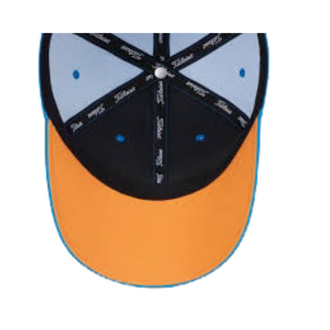 A close-up of the underside of the Titleist Tour Performance Cap reveals a yellow brim, blue and black panels, and black strips with white Titleist logos—showcasing this sporty golf hat by Titleist.