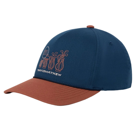 The Travis Mathew Beerly Beloved Snapback Hat in Titan Blue features line art of four golf bags and TRAVISMATHEW embroidered on the front, with a curved brim and classic snapback style.