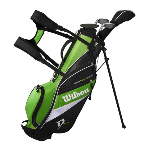 A green, black, and white Wilson 2025 Deep Red Junior Set golf bag (for ages 5-8) stands upright on extendable legs. It includes junior clubs, shoulder straps, and zippered pockets—ideal for young golfers. Brand: Wilson.