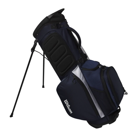 The Wilson 2025 Feather Stand Bag, ultra-lightweight and navy blue, features multiple zippered pockets and compartments. It stands upright on black legs against a white background—ideal for walking golfers.