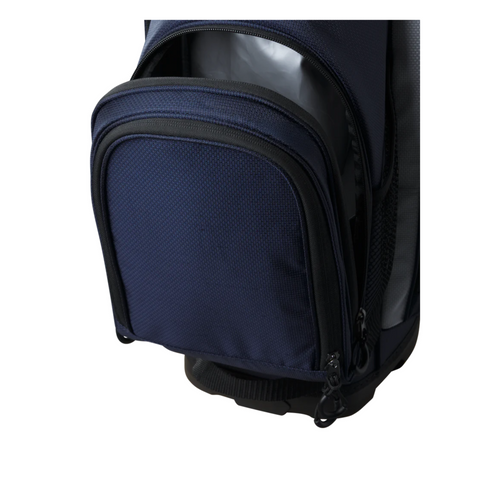 Close-up of the Wilson 2025 Feather Stand Bag by Wilson in navy blue and black, featuring black zippers, gray mesh side panels, and an open front zippered pocket showing a roomy compartment.