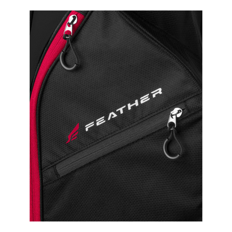 Close-up of the Wilson 2025 Feather Stand Bag in black, with a red zipper, two black zippers, and “FEATHER” plus a red logo on the front—an ultra-lightweight stand bag from Wilson ideal for walking golfers.