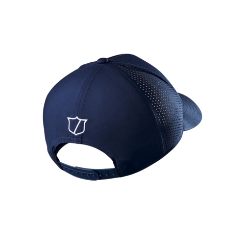 The Wilson 2025 Golf Performance Cap in navy blue is shown from the back, with a white embroidered shield logo above an adjustable snapback. Perforated side panels make this a breathable and comfortable golf cap.