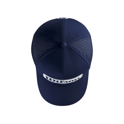 The Wilson 2025 Golf Performance Cap in navy blue, shown from above on a white background, features a breathable mesh back and a front patch displaying Wilson in white letters.