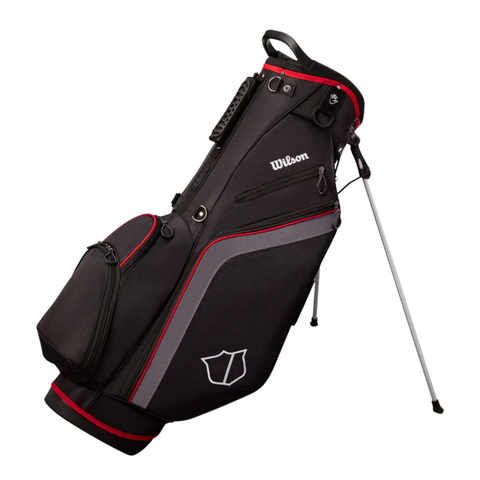 The Wilson Lite Carry Bag in Black/Charcoal/Red by Wilson features side pockets, a padded double strap, handle, and silver stand legs—making it the perfect lightweight golf bag for easy carrying on the course.