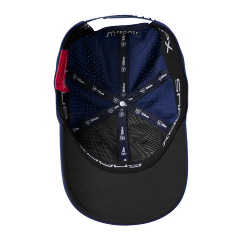 Top view of the Wilson Performance Mesh Cap by Wilson, displaying black mesh panels for breathability, internal stitching, inner brand logos, and a red label near the adjustable strap.