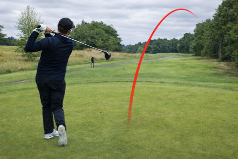 Golfer slicing driver into the trees