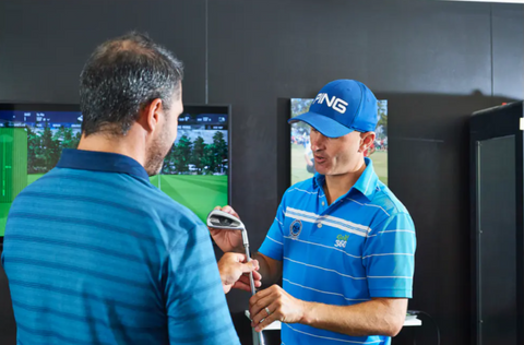 PGA Professional Scott Pickett fitting a customer for a set of irons