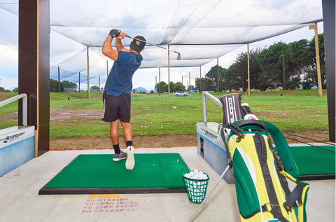 Golfer hitting down the range at Golf 360 