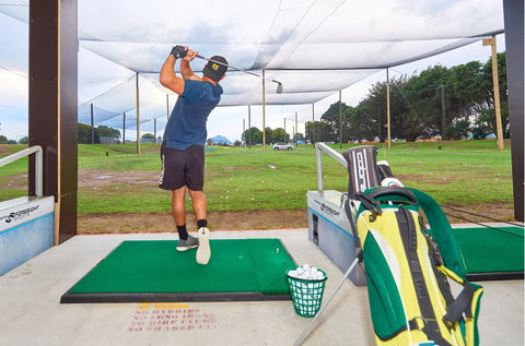 Golfer practising on the driving range at Golf 360