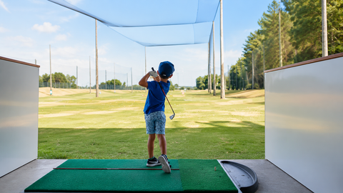 Junior golfer hitting balls at the Golf 360 driving range in Mount Maunganui