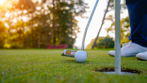 Golfer putting from close to the hole