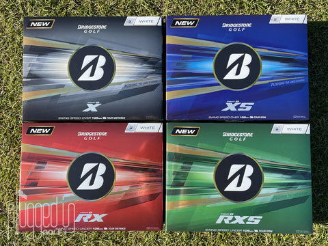 Bridgestone Tour B golf ball range including the Tour B X, XS, RX, and RXS models displayed on grass, showing the different performance options within the Bridgestone lineup.