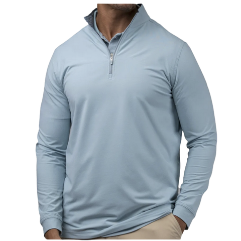 A male wearing a pale blue Greg Norman Pullover