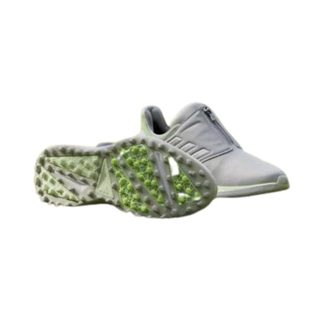 The Adidas 2024 Women's Solarmotion BOA Spikeless Golf Shoes in Grey/Green feature a BOA Fit System and textured green-accented soles, designed for comfort and easy adjustment, displayed against a white background.