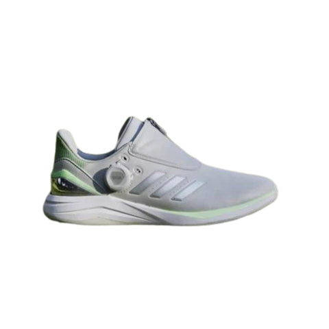 The Adidas 2024 Women's Solarmotion BOA Spikeless Golf Shoes in grey/green feature a sleek, modern look with white accents, three side stripes, no visible laces thanks to the BOA Fit System, and a unique circular heel detail.