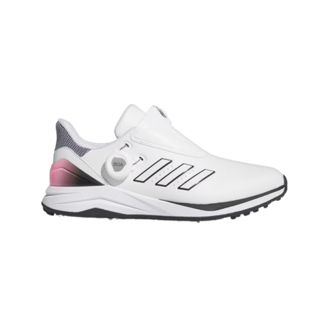 The Adidas 2024 Women's Solarmotion BOA Golf Shoes in White/Black/Pink feature stylish spikeless design, three black stripes, a pink gradient heel, and a BOA Fit System dial.