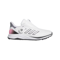 The Adidas 2024 Women's Solarmotion BOA Golf Shoes in White/Black/Pink feature stylish spikeless design, three black stripes, a pink gradient heel, and a BOA Fit System dial, shown against a plain white background.