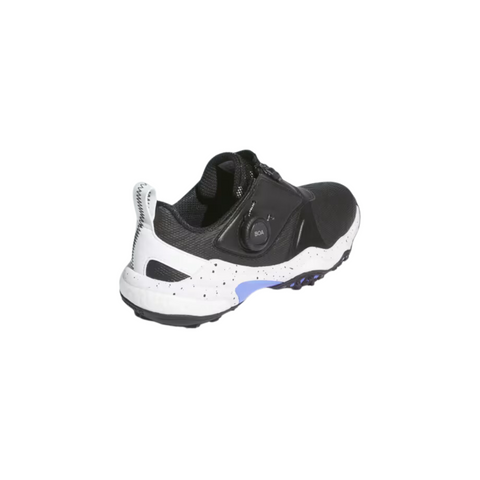 The Adidas 2025 Women's Codechaos Boa Spikeless Golf Shoe in Black/White/Cobalt Blue features a side Boa Fit System dial and heel pull tab. The shoe is angled to showcase the back and outer side, highlighting its stylish speckled sole design.
