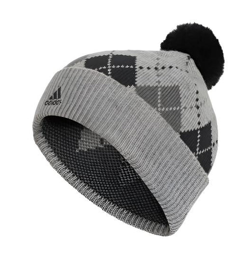The Adidas Women's Graphic PomPom Beanie in Grey/Black features a stylish argyle pattern, a graphic pompom, and the Adidas logo on the ribbed brim, all showcased on a clean white background.