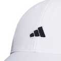 Close-up of the Adidas Womens Logo Patch Cap—a stylish white golf cap with a black and white logo patch, curved brim, visible seams, and AEROREADY technology for moisture management by Adidas.