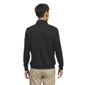 A man with short dark hair, seen from the back, wears an Adidas Mens Core Lightweight Zip Top in black and beige pants, standing against a plain white background.