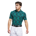 A man wearing an Adidas Mens Go-To Printed Polo Shirt in Pure Teal/Ivy, paired with white pants and a black belt, stands against a white background looking to his left.