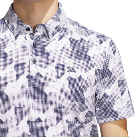 Wearing the Adidas Men's Go-To Printed Polo Shirt in White/Collegiate Navy, a geometric-patterned golf shirt with the Adidas logo.