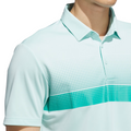 A person wearing an Adidas Mens Performance Chest Stripe Print Polo Shirt in Flash Aqua, featuring a white and teal dotted stripe across the chest. Only the upper torso and part of the face are visible.