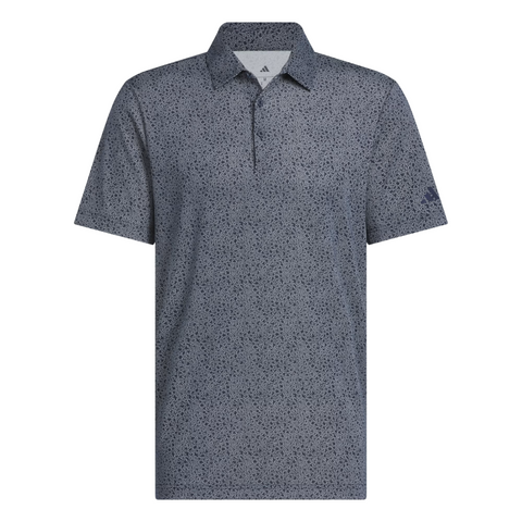 The Adidas Mens Ultimate365 Bunker Polo Shirt in Collegiate Navy features short sleeves, a collar, a buttonless placket, a dark blue and gray speckled pattern, and an embroidered logo on the left sleeve.