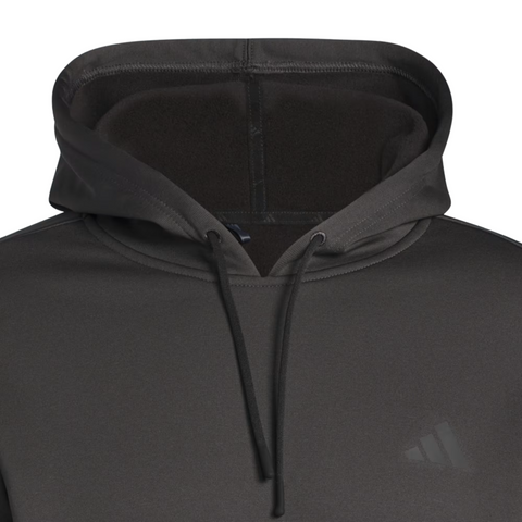 A close-up of the Adidas Mens Ultimate365 Hoodie in black, featuring drawstrings, a subtle chest logo, and a four-way stretch fleece fabric for comfort and flexibility. The hood is worn up.