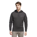A young man stands facing forward against a white background, wearing the Adidas Mens Ultimate365 Hoodie—a black, four-way stretch fleece golf hoodie with a subtle chest logo—and light gray pants.