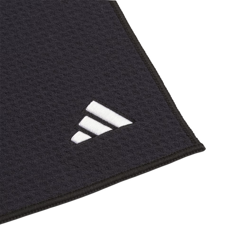 A close-up of the Adidas Players Towel in black, featuring a textured microfiber finish and a white embroidered Adidas logo in one corner, set against a white background.