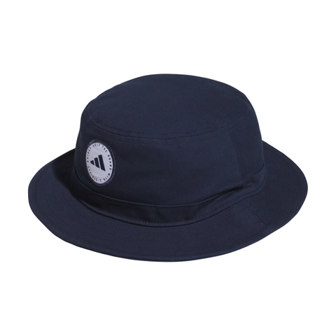 The Adidas Solid Bucket Hat | Collegiate Navy features a circular white patch with the black Adidas logo and a wide, downward-sloping brim for great sun protection, making it an ideal, simple golf hat.