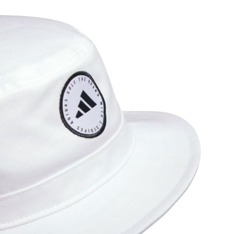 A close-up of the Adidas Solid Bucket Hat in Collegiate Navy, featuring a circular Adidas Golf patch on the front for style, with moisture-wicking comfort and sun protection.