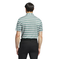 A man, seen from behind, wears an Adidas Two-Colour Striped Men's Polo Shirt—green and white stripes—paired with black pants and a black belt, set against a white background.
