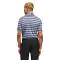 A man with short blond hair is seen from behind wearing an Adidas Two-Colour Striped Men's Polo Shirt and black pants, standing against a white background.