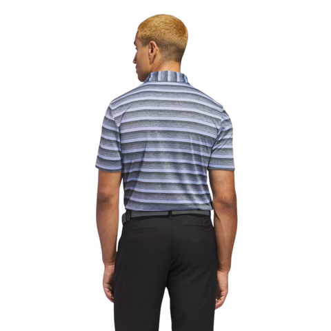 A man with short blond hair is seen from behind wearing an Adidas Two-Colour Striped Men's Polo Shirt and black pants, standing against a white background.