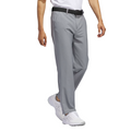 A person is shown from the shoulders down against a white background, wearing Adidas Ultimate365 Men's Golf Pants in light gray, paired with a black belt and white athletic shoes.