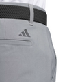 Close-up of Adidas Ultimate365 Mens Golf Pants with a back pocket, black woven belt, and Adidas logo above the pocket. The moisture-wicking pants are styled with a tucked-in white shirt for a clean golf look.