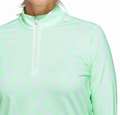 A woman models the Adidas Women's Ultimate365 Printed Quarter-Zip Pullover in light green, featuring a high collar and zip front, shown from shoulders to chest against a plain background.