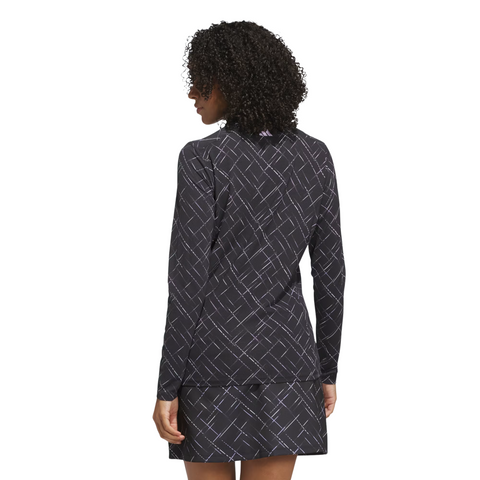 A person with curly hair is shown from the back, wearing a long-sleeve, black and powder plum Adidas Ultimate365 Printed Quarter-Zip Polo Shirt featuring a light diagonal grid pattern.
