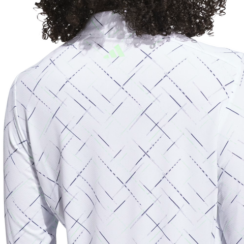 The image shows the back of a person wearing the Adidas Ultimate365 Printed Quarter-Zip Long-Sleeve Polo Shirt in white, featuring a subtle diagonal line pattern. The persons curly hair is visible at the top of the image.