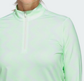 A woman models the Adidas Women's Ultimate365 Printed Quarter-Zip Pullover in light green, featuring a high collar and zip front, shown from shoulders to chest against a plain background.