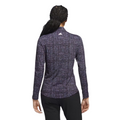 The Adidas Ultimate365 Women's Long Sleeve Golf Shirt in Black Noir, worn by a model and shown from the back, features a grid-like abstract pattern in purple, blue, and white on a black background, with an Adidas logo at the neck.