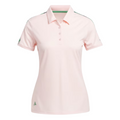 The Adidas Ultimate365 Womens Printed Polo is a light pink, short-sleeve golf shirt with a collar, button placket, green Adidas logo on the lower right, and subtle green detailing on the shoulders and inner collar. Moisture-wicking for comfort.
