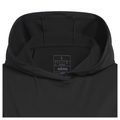 Close-up view of the hood from the Adidas women's performance golf hoodie in black. The interior label is visible, showing size and Adidas branding. The fabric appears smooth and lightweight.