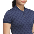 A woman wears the Adidas Womens Ultimate365 Jacquard Short Sleeve Polo Shirt in Collegiate Navy; only her lower face, torso, and a tattooed arm are visible.