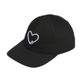 Front of a black Adidas Golf Love hat with a white embroidered heart design, featuring a golf tee forming the heart’s base. Simple and minimalistic style.